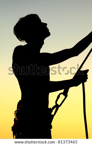 Silhouette insuring climber