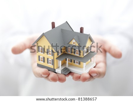 Yellow house in hands Royalty-Free Stock Photo #81388657