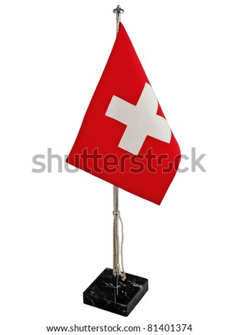 Stylish office bright swiss flag or red pennant with white cross with vintage chromium-plated flagstaff or flagpole on the marble stand