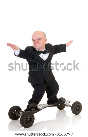 Little businessman, dwarf in a formal suit with bow tie surfing on skateboard, mountain board, studio shot, white background Royalty-Free Stock Photo #8163799