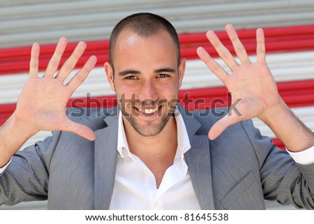Attractive man showing hand palms to camera