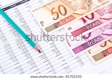 datasheet, Brazilian money and green pencil Royalty-Free Stock Photo #81702250