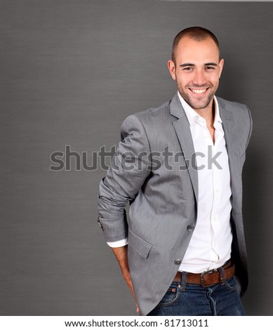 Cool businessman standing on grey background Royalty-Free Stock Photo #81713011