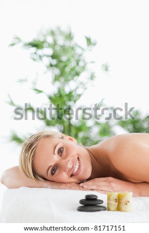 Smiling blonde woman lying on a lounger in a wellness center