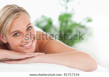 Close up of a blonde woman lying on a lounger in a wellness center