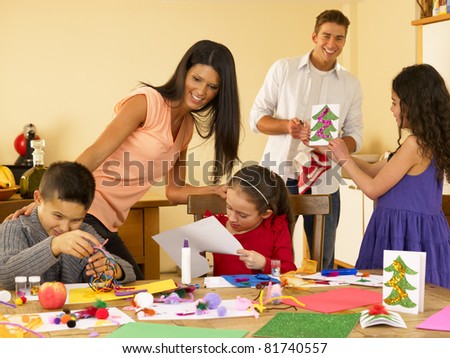 Hispanic family making Christmas cards