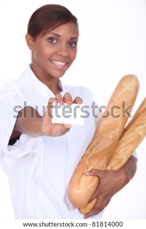 Female baker holding baguettes and a blank business card