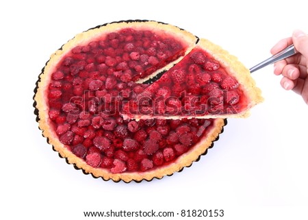 Raspberry Tart - a portion on a cake server being held by a woman's hand
