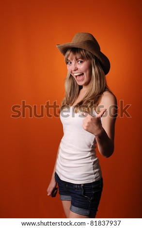 happy young teenager girl isolated on orange background
