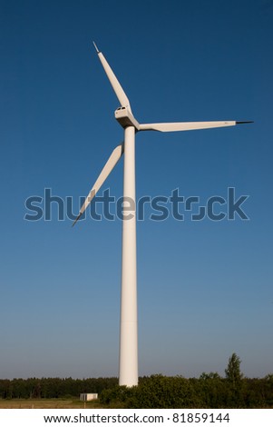 a picture of a large electric windmill against a blue sky