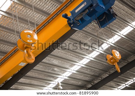 Close up of a factory overhead crane Royalty-Free Stock Photo #81895900