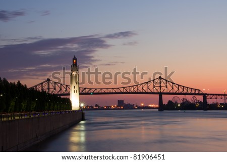 St. Lawrence River with Big Ben in Old Montreal, and Jacques-Cartier Bridge in background, with a beautiful sunrise. Royalty-Free Stock Photo #81906451