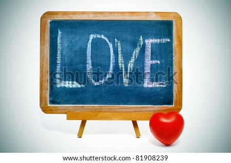 word "love" written in a blackboard and a red heart