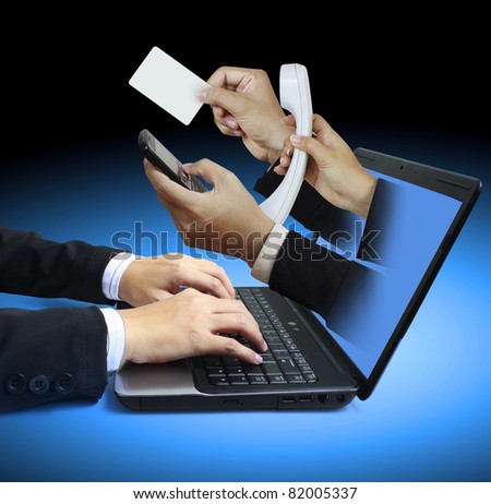 hand sticking through a laptop giving a card and a telephone