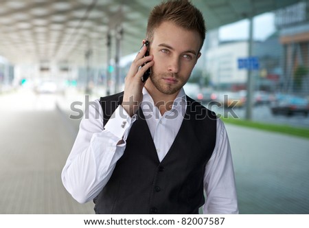 Young man using phone. Outdoors photo.