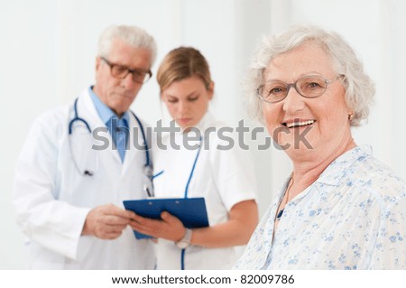Happy senior woman smiling at camera after her medical exam at hospital