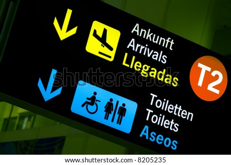 Arrivals and toilets sign panels in airport, Malaga.