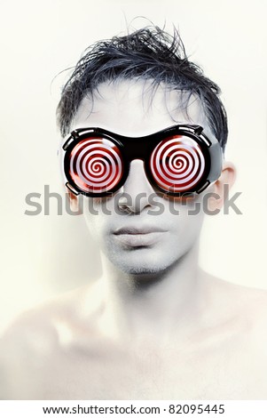 Portrait of a young man with white skin in strange glasses