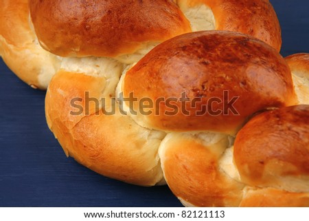 sweet bread : golden challah over blue wooden plate