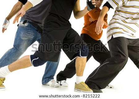 Group of young men standing in bboys pose. We can't see their's faces. White background