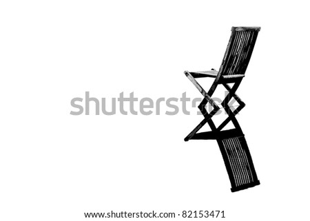 Old wooden chair in calm water with reflection, symbolizing peace, loneliness and emptiness