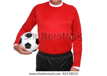 Photo of a football or soccer player holding a ball at his side, isolated on a white background.