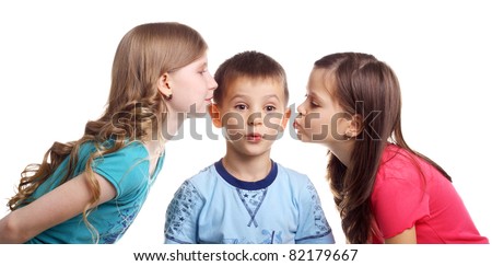 two little girls kissing surprised little boy