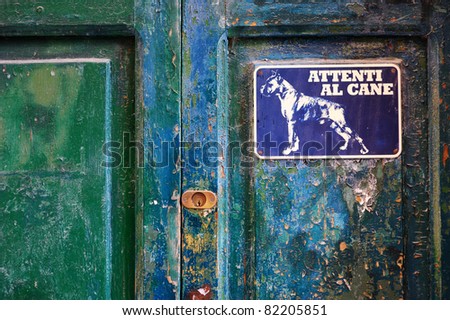 Angry dog sign on a door, Italy