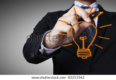 hand with a pen drawing light bulb Royalty-Free Stock Photo #82253362