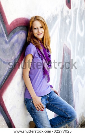 	Style girl near graffiti wall.