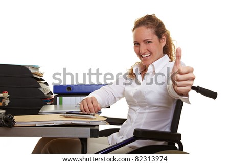 Happy disabled business woman in wheelchair holding thumbs up