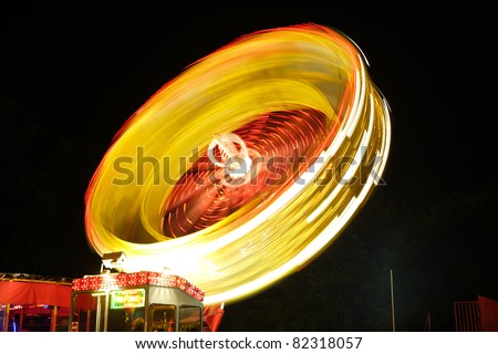 Fairground Ride at Night. Time lapse photography.