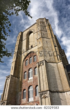 Tower of an ancient Dutch church with dramatic clouds