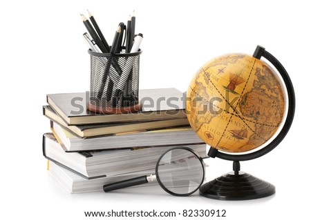 Vintage globe, stack of books and office supplies isolated on white background.