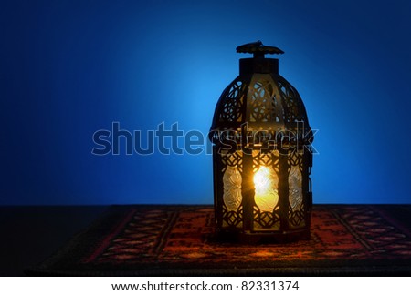 An illuminated Arabic lantern on blue background Royalty-Free Stock Photo #82331374