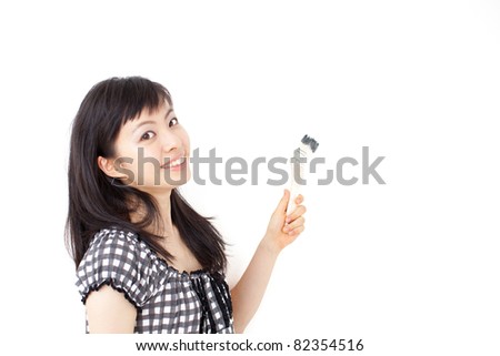 young woman painting something with paintbrush, isolated on white background