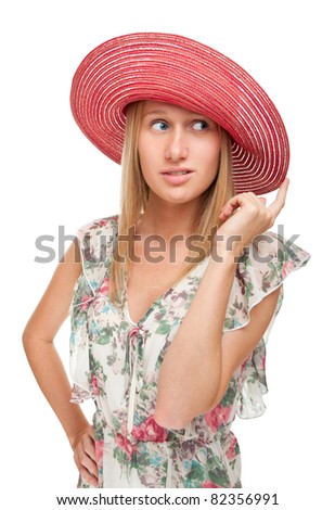 Studio portrait of a pretty young woman in a red hat on a white background