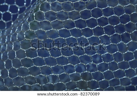 Fabric. Golden mesh on the blue background