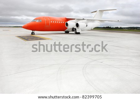 A picture of an orange business jet on the apron, space for your text