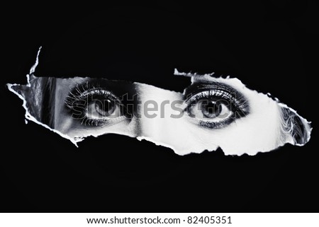 Women's bl eyes spying through a hole