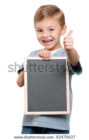 Portrait of a little boy holding a blackboard over white background