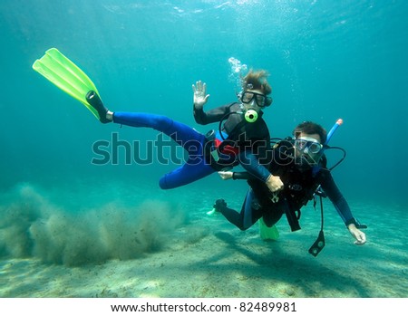 Father teaching his little son it dive Royalty-Free Stock Photo #82489981