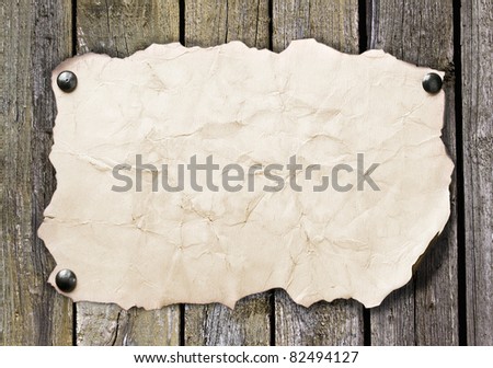 Old paper nailed to a wooden wall
