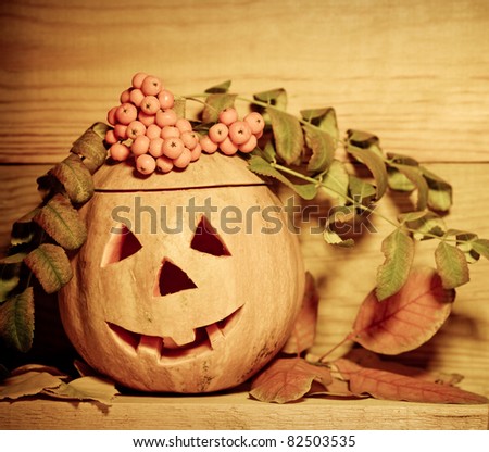 Handmade Halloween pumpkin on wooden background. Autumn holidays concept