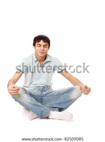 A handsome man relaxing in a lotus position, isolated on white