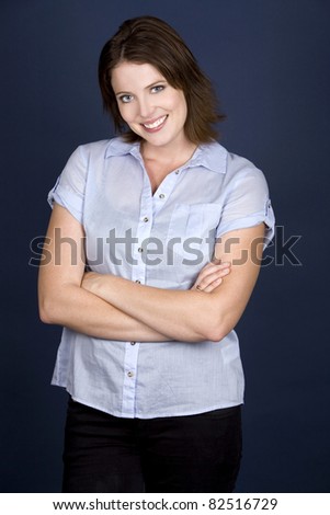 pretty casual brunette wearing blue top on dark background