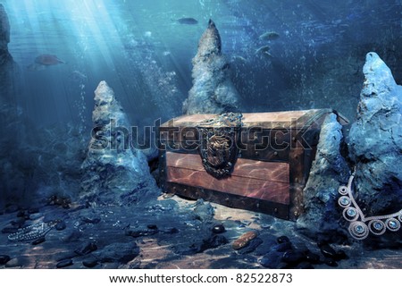 photo of wooden treasure chest submerged underwater with light rays