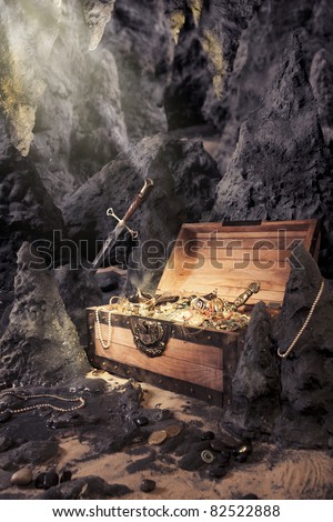 photo of open treasure chest with shinny gold in a cave Royalty-Free Stock Photo #82522888