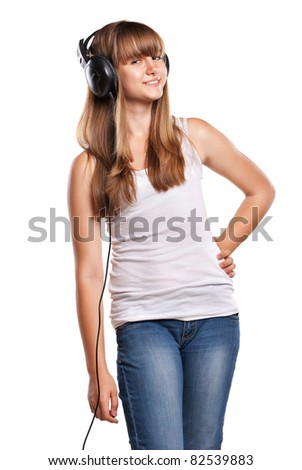 Lovely girl listening a music in headphones, white background