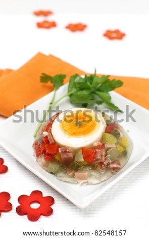 Delicious holiday aspic with vegetables, ham and egg on top